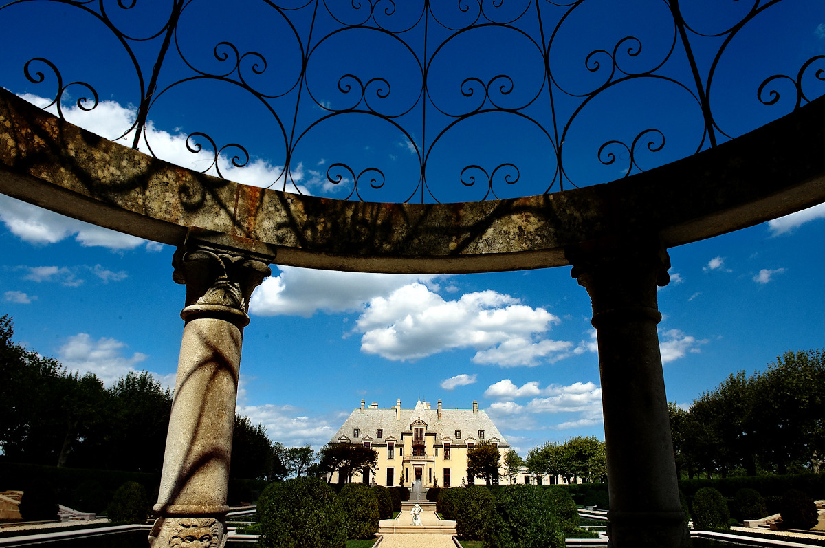 Ornate Italian villa framed by a stone colonnade