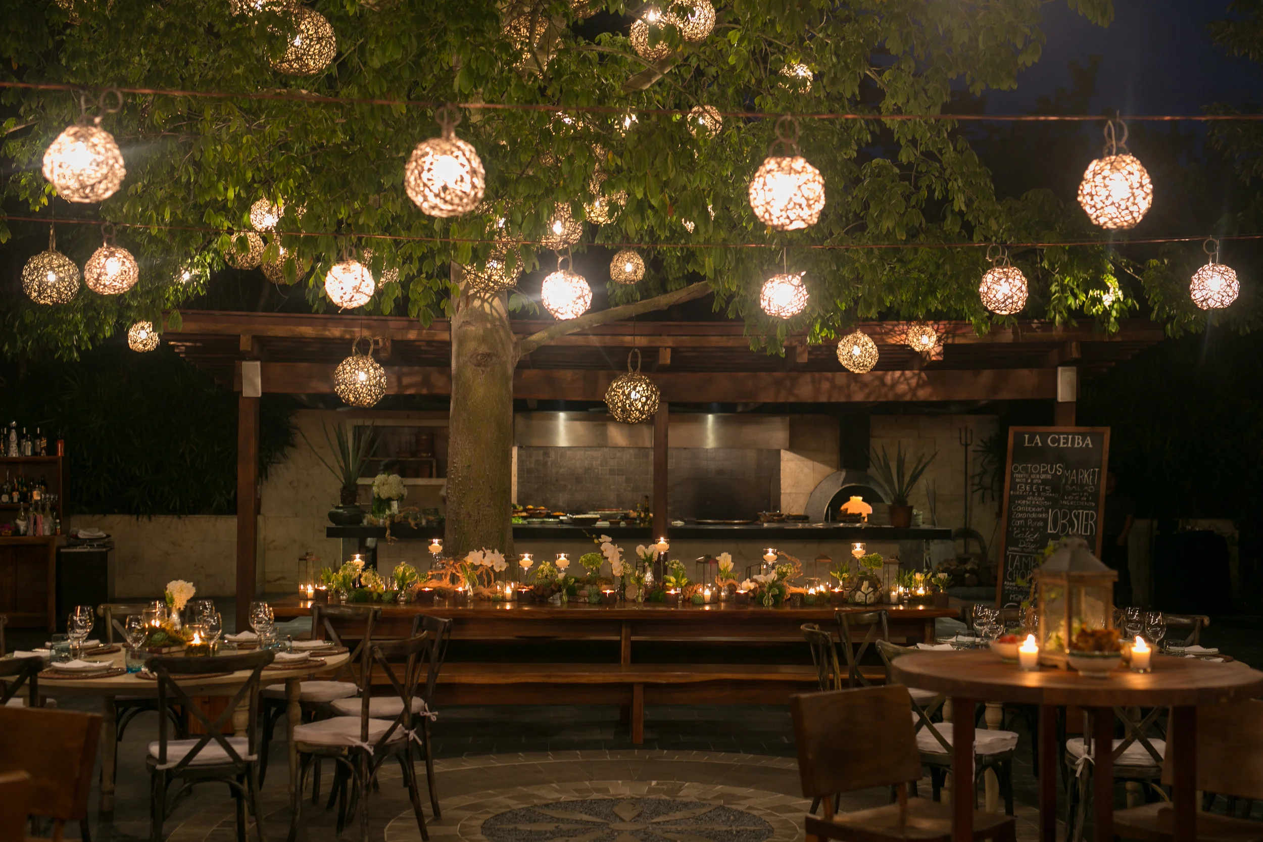 Warm open-air reception with hanging globe lights at Rosewood Mayakoba