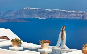 Bride overlooking the blue sea in Santorini