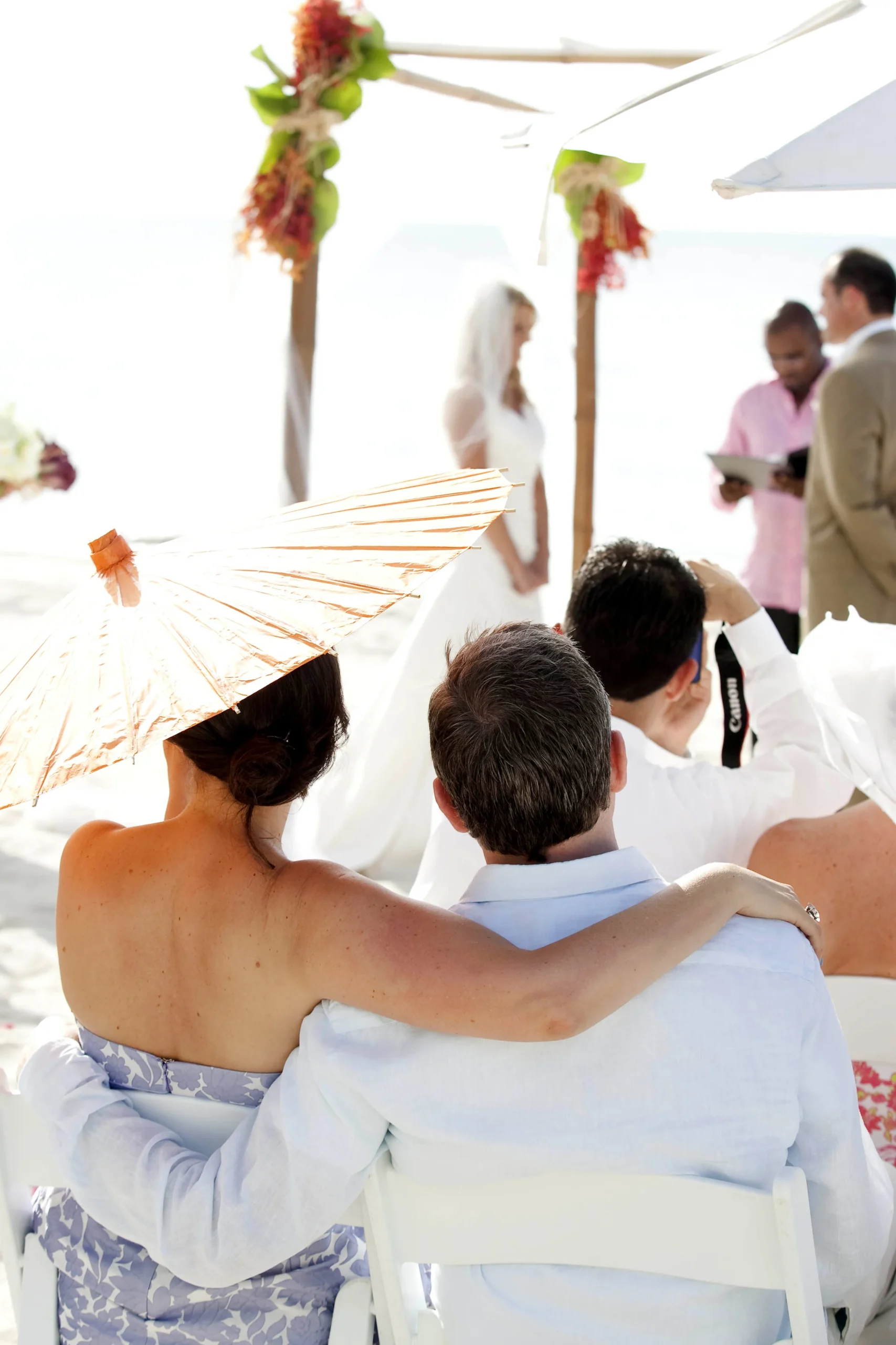 Wedding guests watching a bright outdoor ceremony