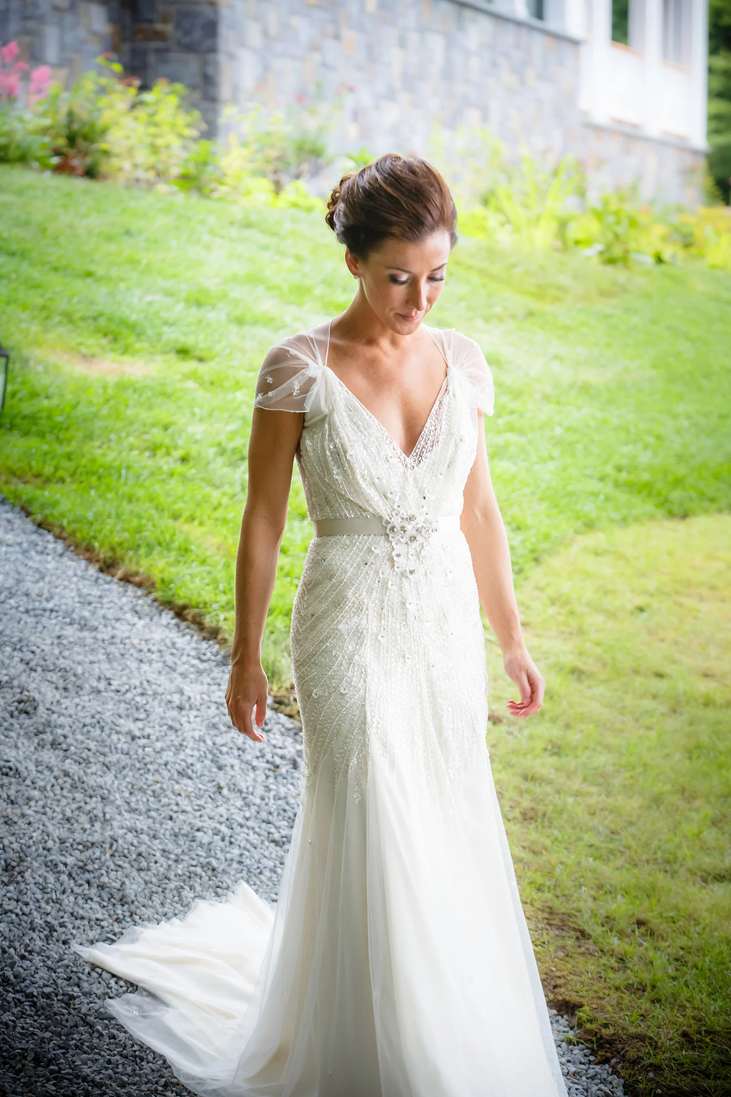 Bride in a fitted lace wedding gown outdoors