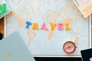 Travel planning flat lay with map, passport and compass