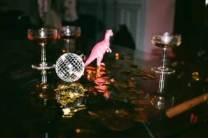 Disco ball centerpiece with coupe glasses and playful pink decor