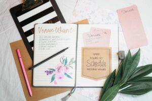 Wedding planning notebook and stationery arranged on a desk