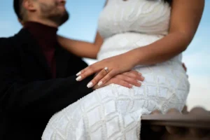 Close-up of a bride's wedding ring as she sits beside her partner