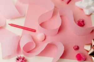 Pink party decor with ribbons, confetti and small accessories