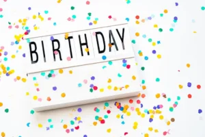Birthday sign surrounded by colorful confetti