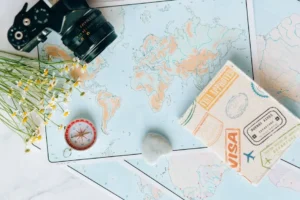 Destination travel flat lay with map, passport, camera and compass