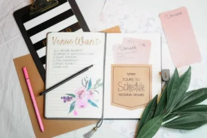 Wedding planning notebook and stationery arranged on a desk