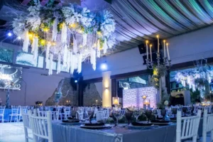 Luxury reception with dramatic blue lighting and hanging white florals