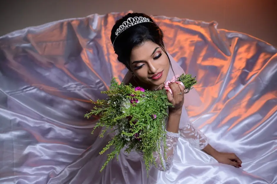 Bride posing with a bouquet in a dramatic flowing gown