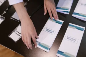 Corporate event materials and name badges arranged on a table