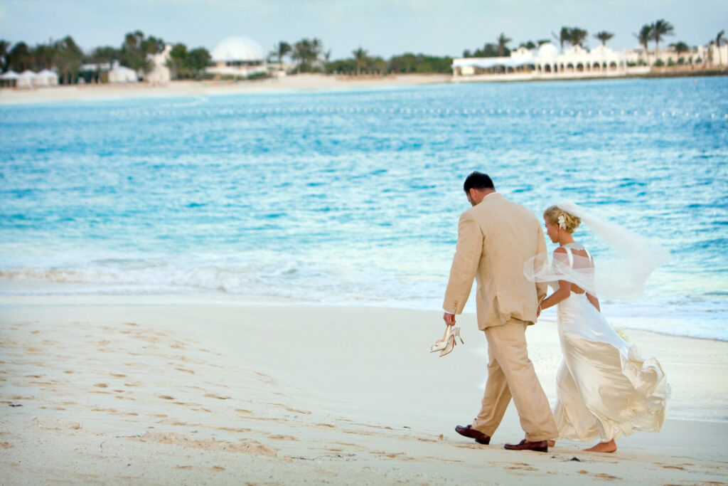 Bride and groom walking along the beach at Cap Juluca in Anguilla
