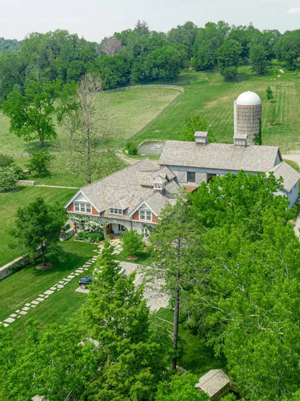 Aerial view of a private estate and surrounding grounds prepared for a luxury tented wedding.